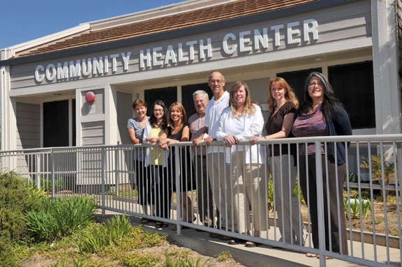 A group of people standing in front of a Community Health Center